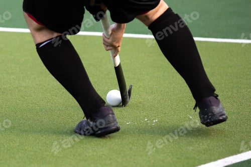 Preview: Field hockey player on artificial grass play field.