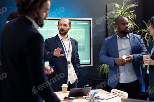 Preview: Team members from a business corporation discussing details and progress