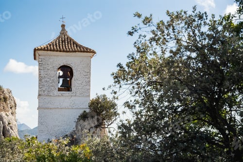 Preview: Belfry of Guadalest beautiful Spanish village, blue sky on the background