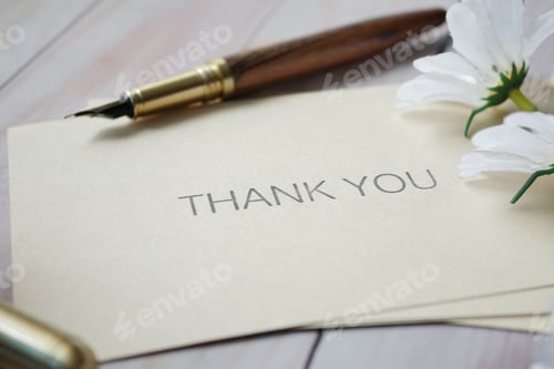 Preview: thank you message and envelope on wooden table