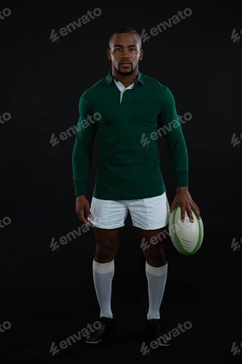 Preview: Portrait of male rugby player holding ball