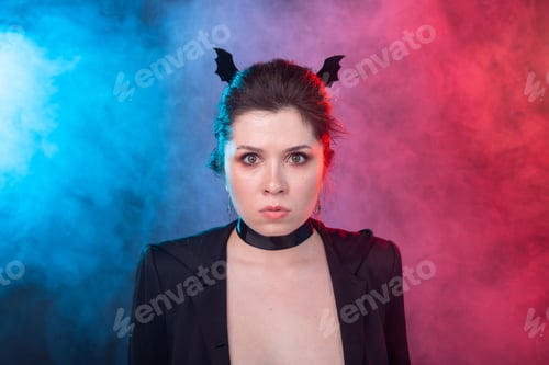 Preview: Halloween, holidays and carnival concept - vamp woman in jacket and with bat ears in gothic style