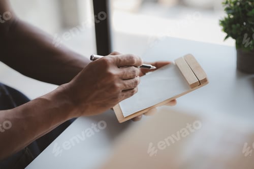 Preview: Online store owner checking product order before shipping to customer.