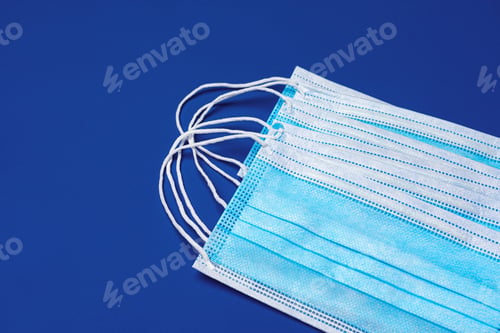 Preview: Medical face mask on blue background. Coronavirus prevention concept