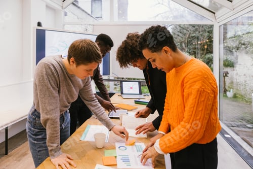 Preview: Marketing team analyzing charts and reports in modern office