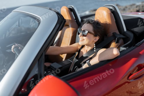 Preview: Woman driving a cabriolet on a summer time