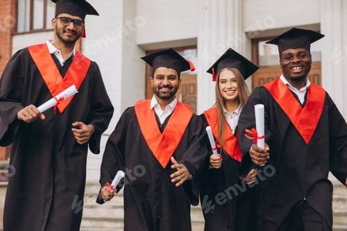 Preview: Diverse Group of Happy Graduates Celebrating Together in Cap and Gown Outside University Building
