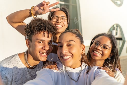 Preview: Group of happy teenage friends taking a selfie looking to the camera. Selfie group portrait.