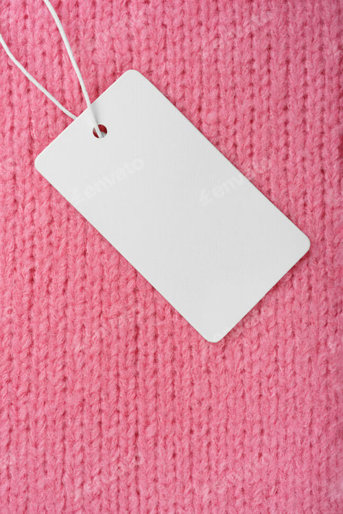 Preview: Template Of Blank Clothing Label, Price Tag On Pink Knitted Sweater Background