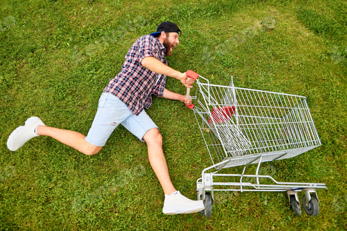 Preview: Young man with supermarket cart