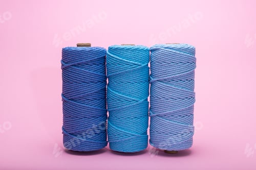 Preview: Three Blue Macrame Cord Spools Against a Pink Background