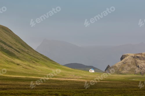 Preview: Picturesque shelter in a green misty landscape. Icelandic loneliness scenery