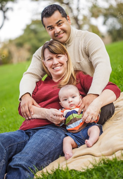 Preview: Happy Mixed Race Family Posing for A Portrait in the Park.