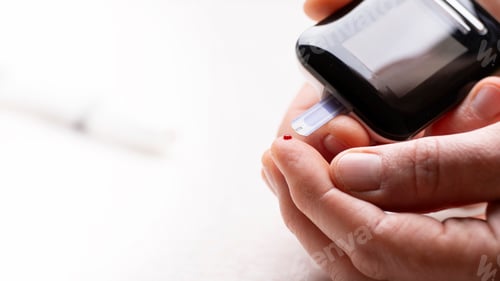 Preview: Pierced caucasian finger ready to measure glucose level by glucose meter closeup view