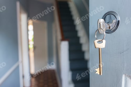 Preview: Front door of house with key in lock