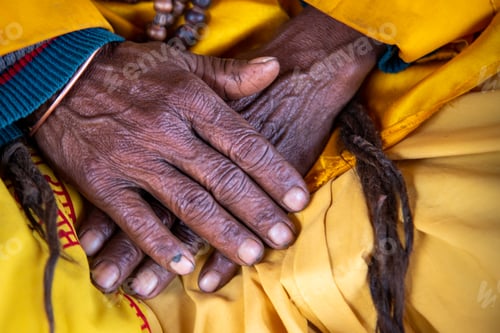 Preview: Close up of the crossed wrinkle hands of an elder grandmother nepalese woman