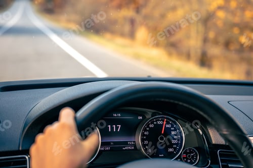 Preview: Steering wheel in a car close up, high speed driving on the road.