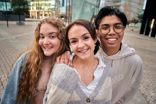 Preview: Portrait of three smiling multiracial young college students. Classmates cheerful and united.