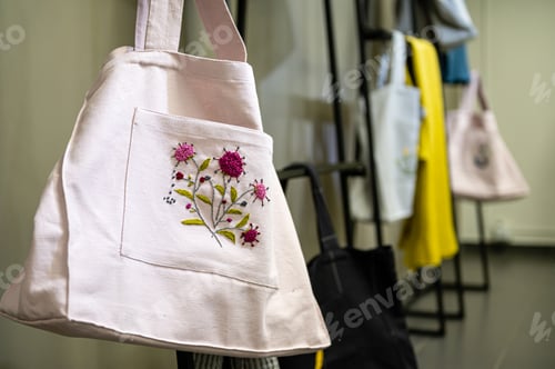 Preview: Unique embroidered bags displayed in a workshop environment for craft enthusiasts