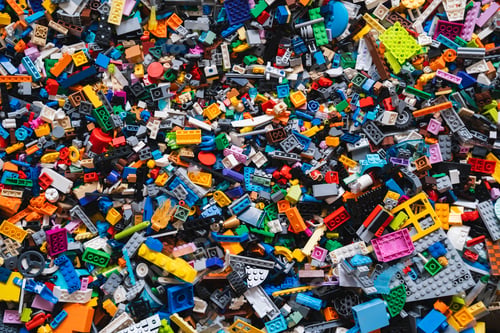 Preview: Colorful background of mixed plastic bricks toys. Building blocks in multiple colours.