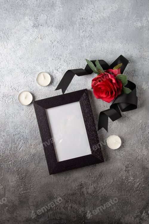 Preview: top view of red flower with picture frame on light surface photo death soldier