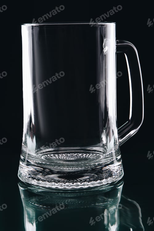 Preview: Empty glass cup for beer on dark background.