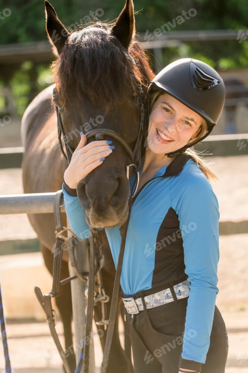 Preview: Vertical shot of a young female with a horse at the farm