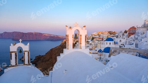 Preview: sunrise by the ocean of Oia Santorini Greece, traditional Greek village