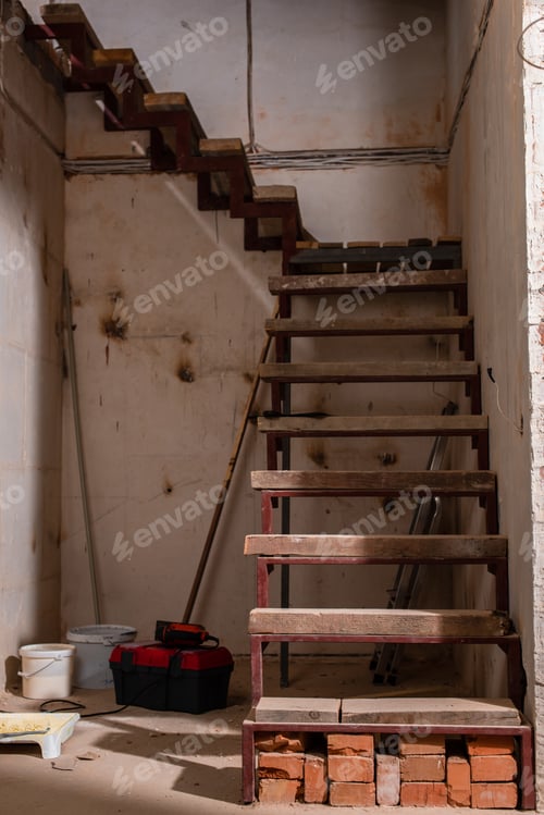 Preview: Unfinished Staircase Construction with Ladder and Tools