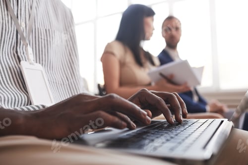 Preview: Man Typing at Business Conference