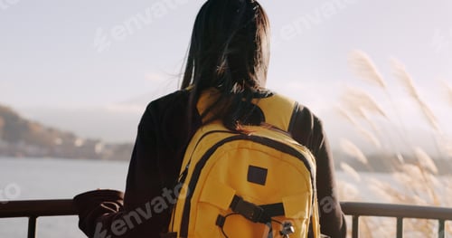 Preview: Woman, water and backpack with back, thinking and mountains on adventure, trip or vacation in natur