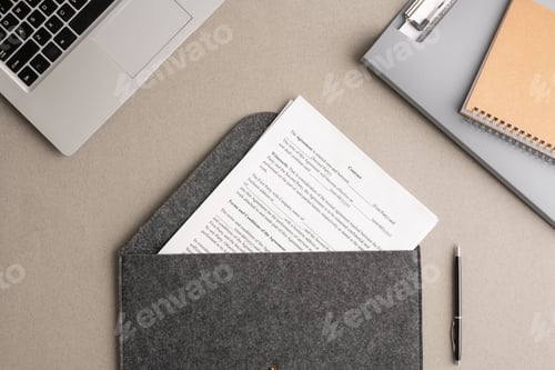 Preview: Overview of financial contract in large grey envelope surrounded by supplies