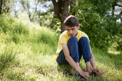 Preview: Sad guy sitting on the grass