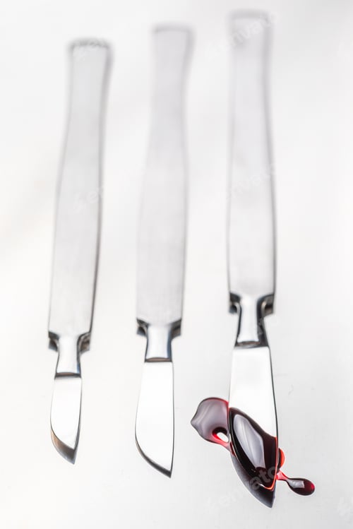 Preview: Closeup of scalpels with a small amount of blood