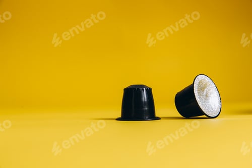 Preview: Coffee capsules of high quality on yellow background