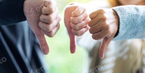 Preview: A group of people making thumb down hands sign in circle