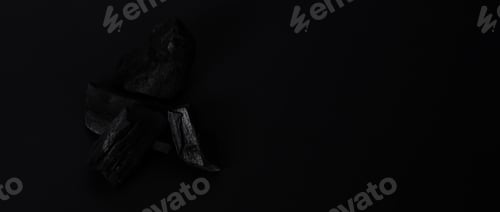 Preview: Wood charcoal. Black Charcoal on black textured floor. Used for cooking