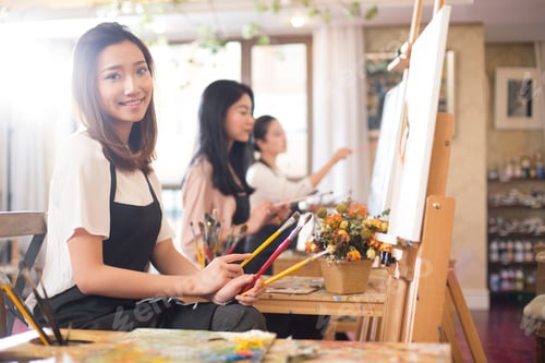 Preview: Young women painting in studio