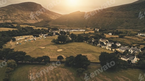 Preview: Sunset aerial at village mountain . Nobody nature landscape at sun set. Cottages, whiskey distillery