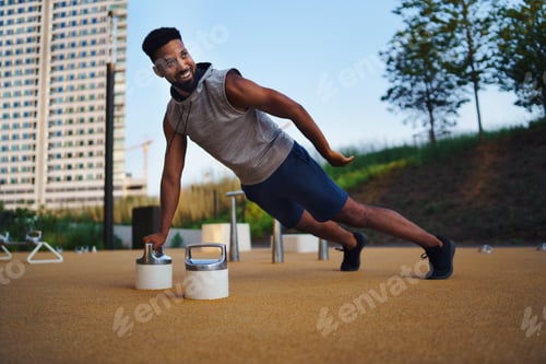 Preview: Man doing workout exercise outdoors in city, push up on one hand