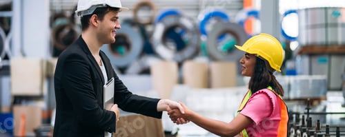 Preview: Team engineers and foreman stack hand and shake hands to show success at factory machines.