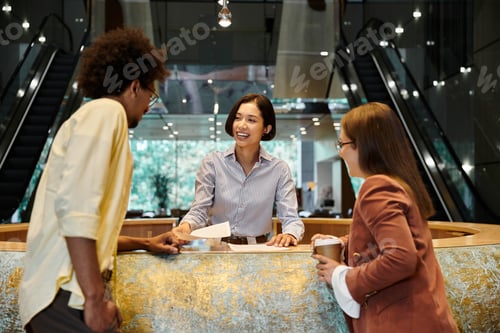 Preview: Diverse colleagues chatting in office lobby