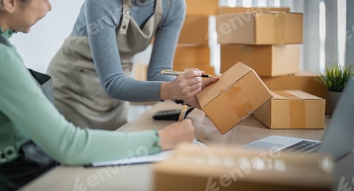 Preview: Startup small business owner working with computer at workplace. Two woman sell check product order