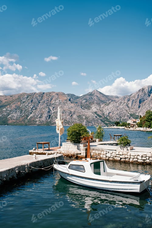 Preview: Small boat is moored at the stone pier of an ancient town