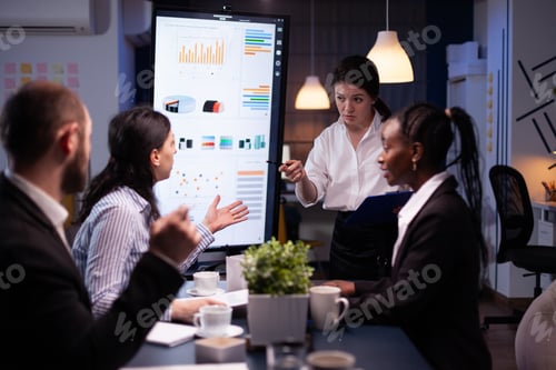 Preview: Multi-ethnic businesspeople discussing financial company solution sitting at conference table