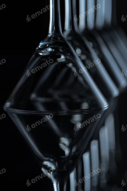 Preview: close up of martini glasses on black with reflections