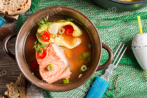 Preview: Closeup of fish soup with dill and chilli pepper