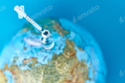Preview: Medical syringe and ampoule with a medicine against Earth globe