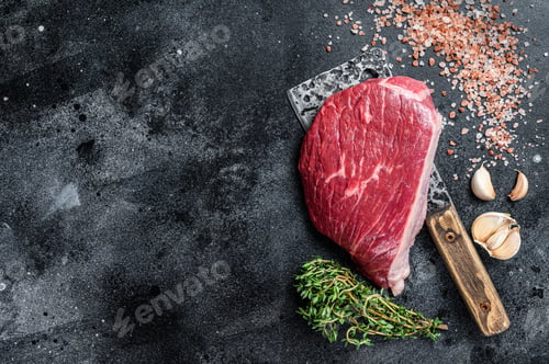 Preview: Fresh Raw rump beef cut or top sirloin cap steak on butcher cleaver. Black background.