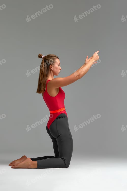 Preview: Young woman wearing sportswear practicing yoga, doing exercise, standing in pose, beautiful sporty